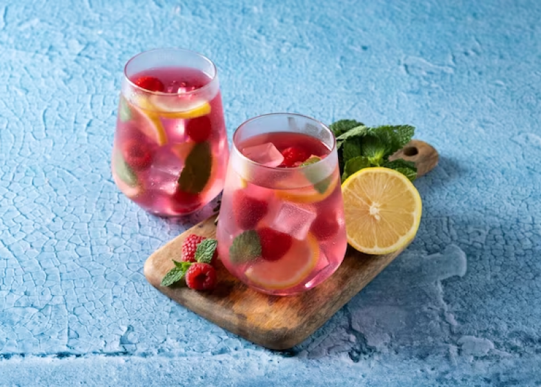 Raspberry fresh lemonade with lemon, strawberry syrup and mint